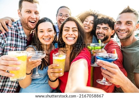 Multicultural group of friends making cocktail party outside - Happy young people taking selfie at bar restaurant - Friendship concept with guys and girls enjoying day out together
