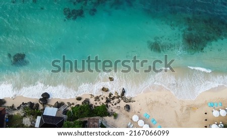 Karma kandara private beach bali aerial top drone view. beach picture with white sand and teal aqua sea water. taken with drone