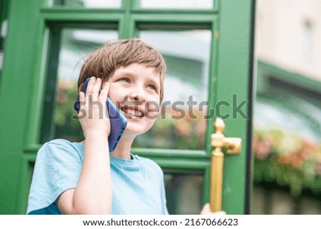 
smiling boy talking on the phone