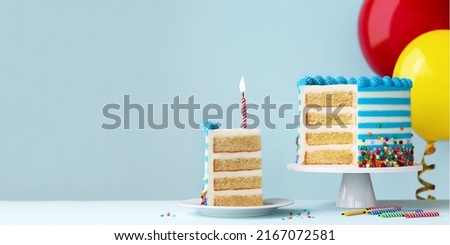 Slice of birthday cake with one red birthday candle and colorful birthday balloons ready for a birthday party Royalty-Free Stock Photo #2167072581