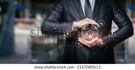 Business man protecting smart home on blurred background.