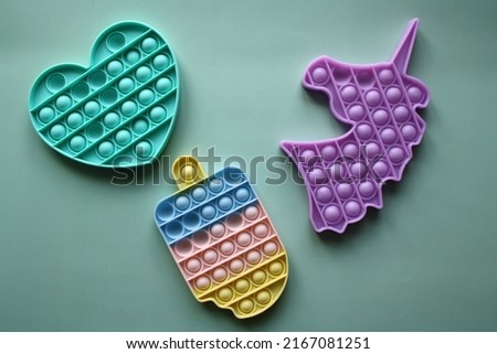 A colorful sensory toy fidget pushes it. Set of children's silicone toys antistress Royalty-Free Stock Photo #2167081251