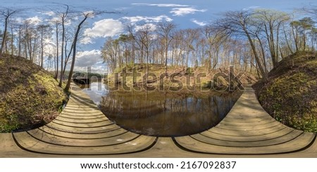 full seamless spherical hdri 360 panorama view on wooden pier of lake or river among forest with beautiful clouds in equirectangular projection, VR content Royalty-Free Stock Photo #2167092837