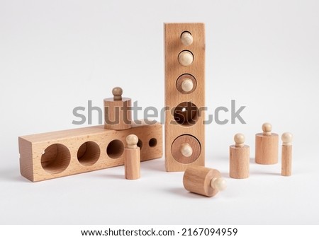 Montessori knobbed wooden cylinders with blocks. Puzzle for teaching child to distinguish small differences in size. High quality photo