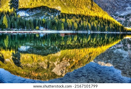 Reflections in the water of a mountain lake in autumn. Autumn mountain lake water reflection. Beautiful lake water reflection. Autumn lake water in mountains Royalty-Free Stock Photo #2167101799