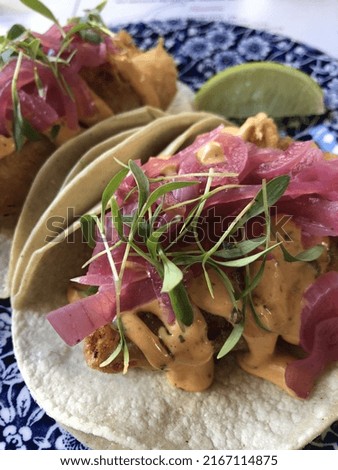 Fried fish tacos with pickled onions, chipotle mayo and greens 