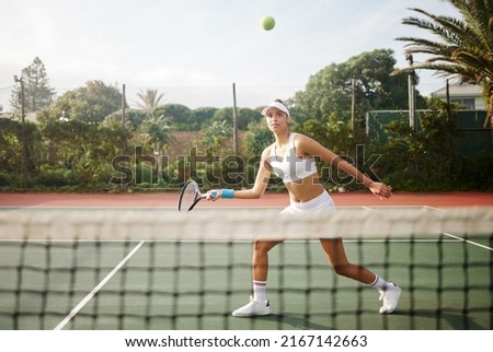 Ill let the racket do the talking. Shot of an attractive young woman playing tennis outside.