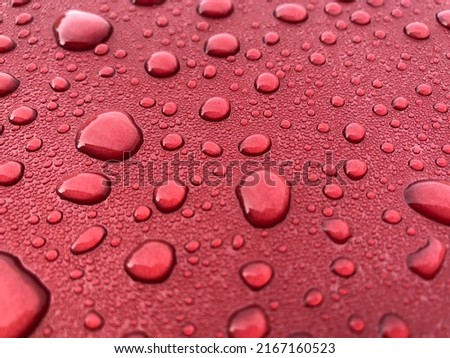 Close up rain drop on red background
