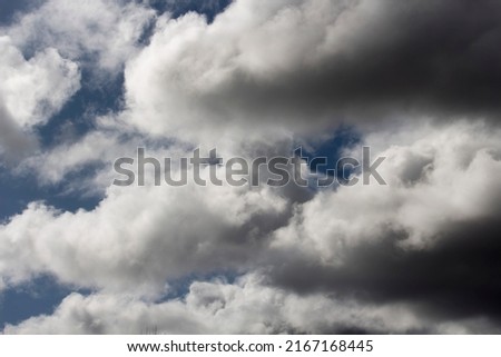 Altocumulus from Latin high and cumulus rounded is a middle-altitude cloud genus that belongs to the stratocumuliform physical category characterized by globular masses or rolls in layers or patches. Royalty-Free Stock Photo #2167168445