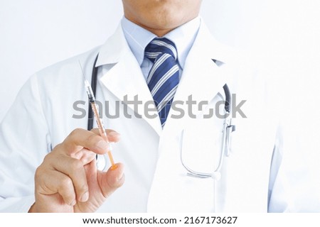 A Japanese doctor with a syringe Royalty-Free Stock Photo #2167173627
