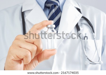 A Japanese doctor with a vial bottle Royalty-Free Stock Photo #2167174035
