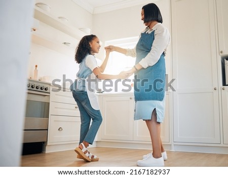 I think my mom is amazing. Shot of a little girl and her mother dancing in the kitchen at home.