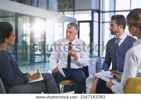 Working on a plan to meet their objectives together. Cropped shot of a group of businesspeople having a discussion in an office. Royalty-Free Stock Photo #2167183383