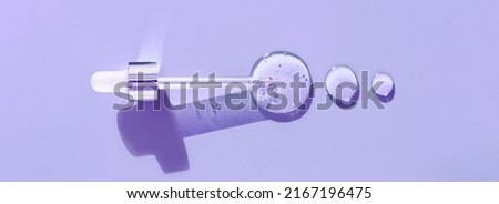 pipette drop of serum test on a purpule background Royalty-Free Stock Photo #2167196475