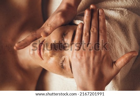 Beautiful woman in spa salon getting face massage treatment. Girl facial treatment. Skin care. Body care. Royalty-Free Stock Photo #2167201991