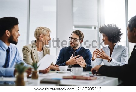 We can finish this if we work together. Shot of a group of businesspeople sitting together in a meeting. Royalty-Free Stock Photo #2167205313