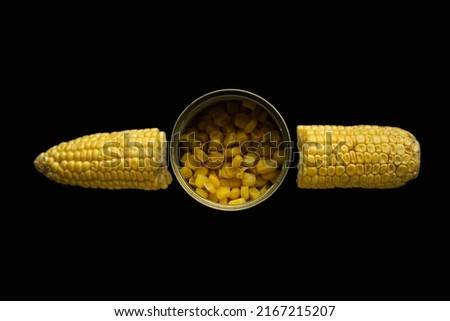A can of sweet corn next to corn cob. isolated on black background. top view.  Royalty-Free Stock Photo #2167215207