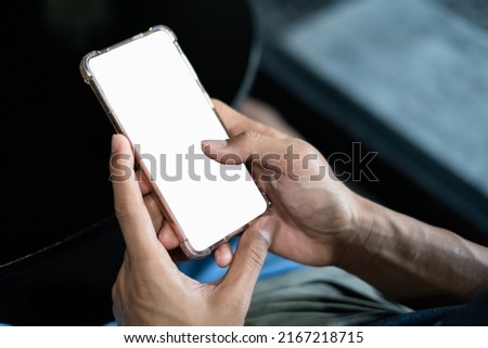 Close up hand using smartphone show white screen for your web site design, logo, app with blurred background.