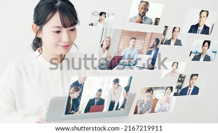 Young Asian woman taking video conference. Online class. e-learning. Hologram screens. Royalty-Free Stock Photo #2167219911