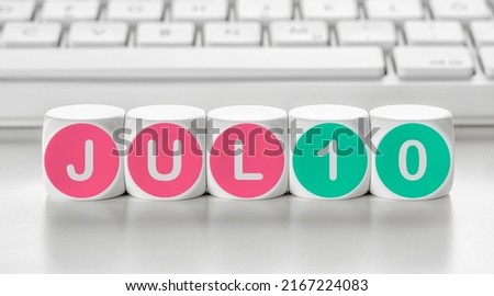 Letter dice in front of a keyboard - July 10