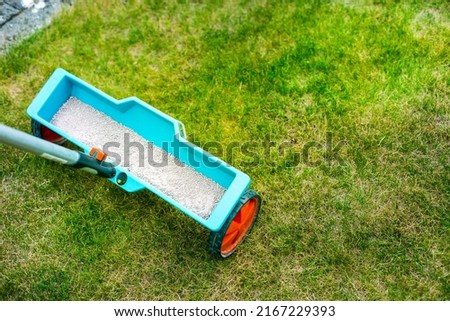 Lawn care - Lawn Spring Fertilization tool Royalty-Free Stock Photo #2167229393