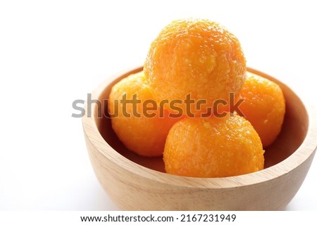 Close up of Indian sweet Motichoor Laddoo or Bundi Laddu. indian sweets fresh ladoo in a wooden bolw. empty space for text, selective focus. Royalty-Free Stock Photo #2167231949