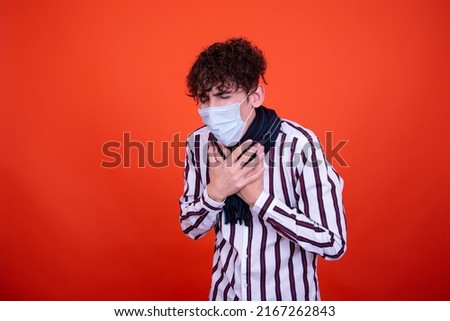 Illness and cold. Handsome guy and orange background.	