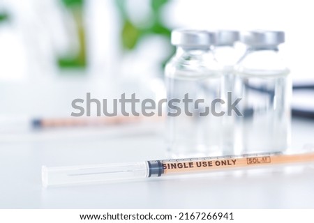 Vial jars and syringes placed on a clean table Royalty-Free Stock Photo #2167266941