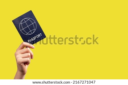 Banner with woman hand holding passport on yellow background. Tourism, going abroad concept. Identity, nationality verification. Place for text. High quality photo