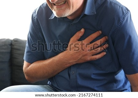 Caucasian man middle age suffering from heart attack at home Royalty-Free Stock Photo #2167274111