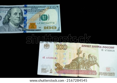 Dollar, Russian ruble and fire from gas on a black background.