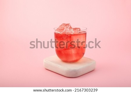 Red summer non-alcoholic drink with ice. Fruit iced tea on pink background. Rose hibiscus refreshing drink. Royalty-Free Stock Photo #2167303239