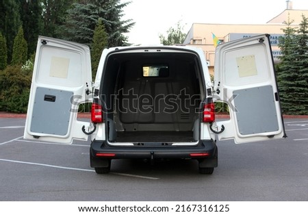 Modern cargo van with open empty trunk. Modern cargo van open trunk. Car boot is open. Modern car with open empty trunk. Royalty-Free Stock Photo #2167316125