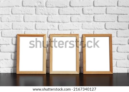 Blank picture frame against  brick wall with copy space for your design