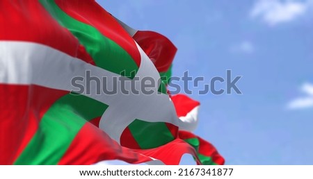 The Basque Country flag waving in the wind on a clear day. The Basque Country is an autonomous community in northern Spain Royalty-Free Stock Photo #2167341877