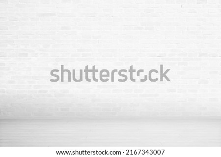 White brick wall and wooden floor. Empty room for copy or product presentation