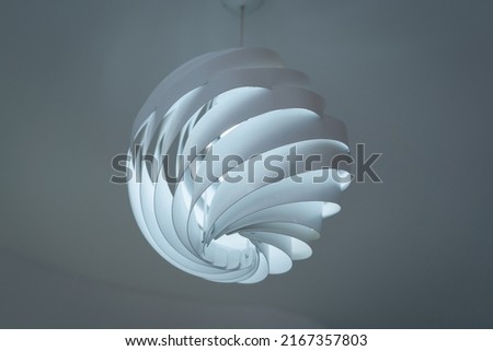 Modern ceiling lamps and light bulbs ball shape decoration for home and living from the plastic sheet sphere spiral shape geometry pattern. Concept interior building contemporary. Royalty-Free Stock Photo #2167357803