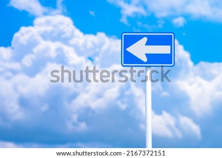 One-way sign and blue sky.