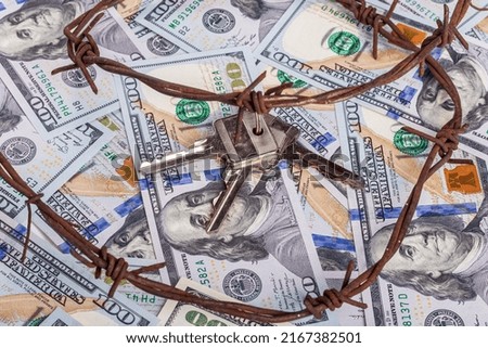 the background of dollars on it is barbed wire. close-up