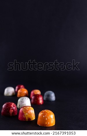 Sweet color chocolate bonbons. Modern hand painted chocolate candy. Product concept for chocolatier Royalty-Free Stock Photo #2167391053