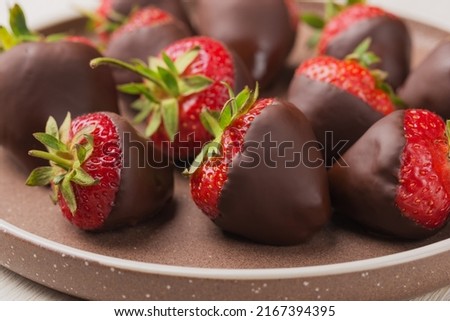 Gourmet chocolate covered strawberries on ceramic plate. Dessert background.  Selective focus. Royalty-Free Stock Photo #2167394395