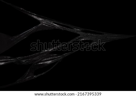 Black symbiote sismucus, sticky slime over dark background Royalty-Free Stock Photo #2167395339
