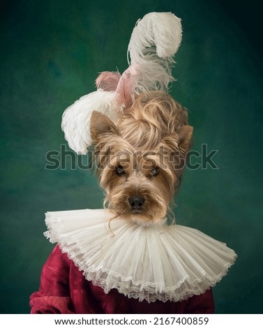 Charming doggy looking at camera. Woman like medieval person in vintage outfit headed by dog's head isolated on dark green background. Comparison of eras, art, renaissance style. Contemporary collage. Royalty-Free Stock Photo #2167400859