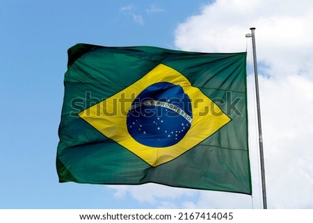 Brazilian flag flying in the wind. Translation: order and progress.