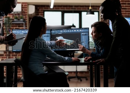 Production department team gathered around 3D artist engineer trying to solve geometry problem. Digital engineering experts collaborating in order to develop advanced scene.