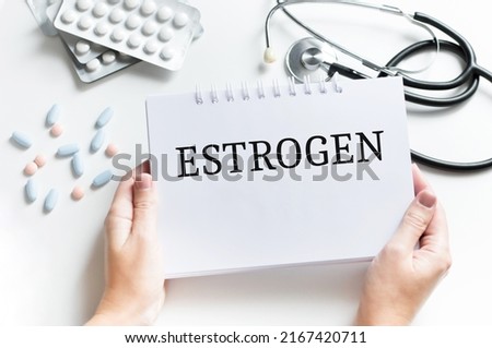 Text STROGEN on a table with stethoscope,pills and pen, medical concept.