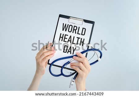 Medic holds a signboard with the text world health day. World Health Day,