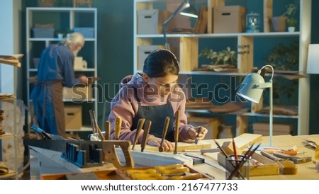 Caring Grandfather with his Teenage Granddaughter Spend Time Together, Work on Wood, Enjoying Communication in the Workshop. Hobby Garage. Communication Between Generations, Family and Mental Health.