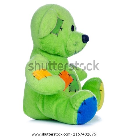 Green small soft toy bear on white background isolation
