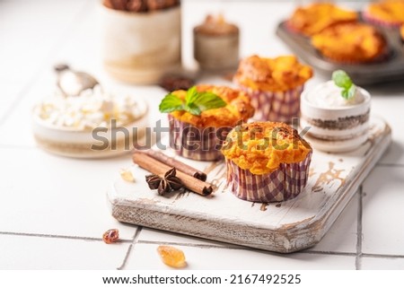 Sweet homemade cottage cheese muffins with pumpkin on white background